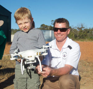 Ray Ewins from 3D Aerial imaging and photography WA demonstrates to future farmer Digby Barrett-Lennard how to operate a drone